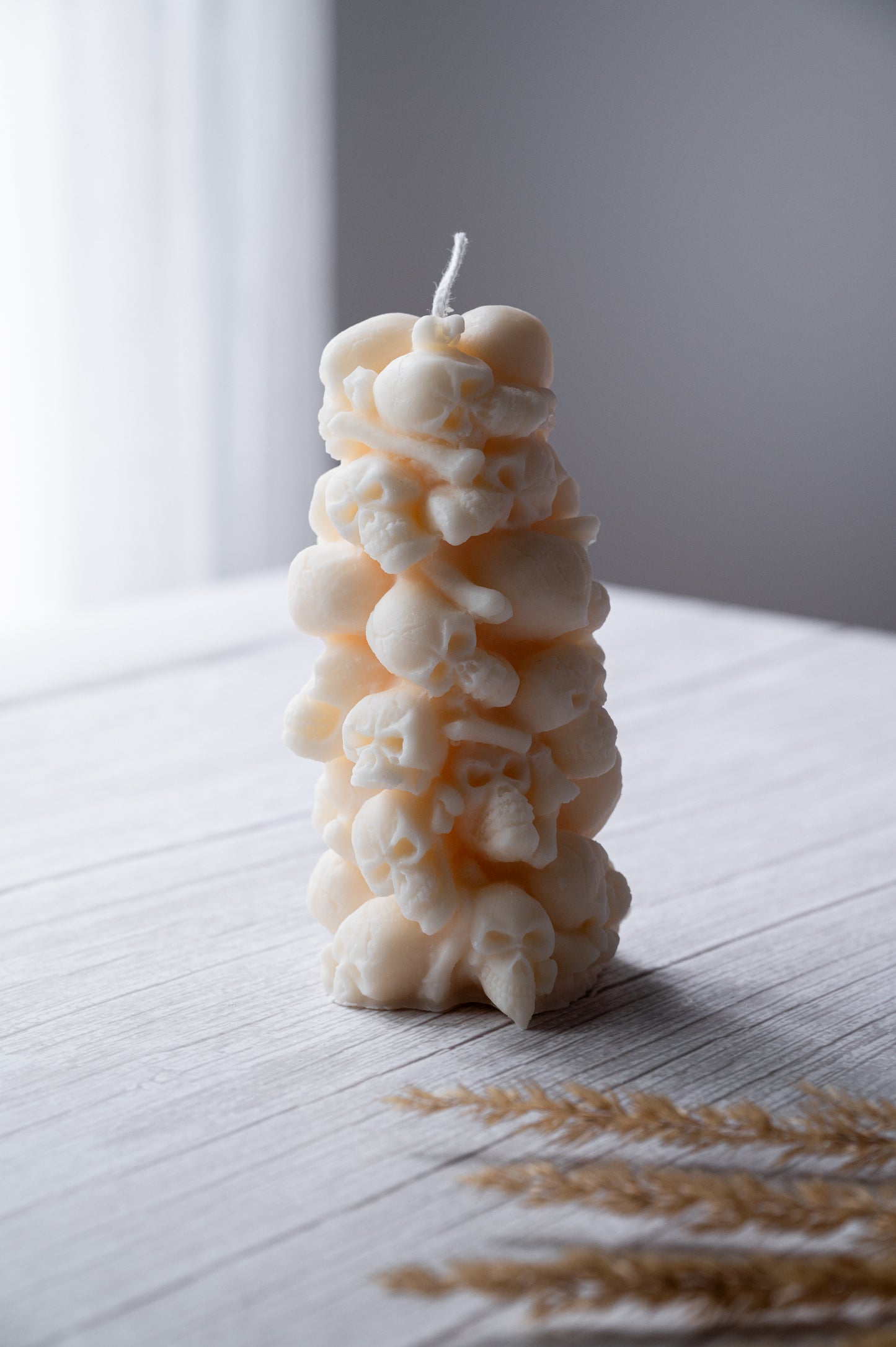 Decorative candle with a textured design on a white surface